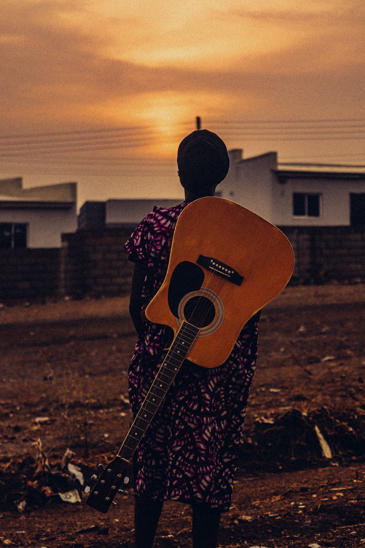 Silhouette with a guitar at sunset