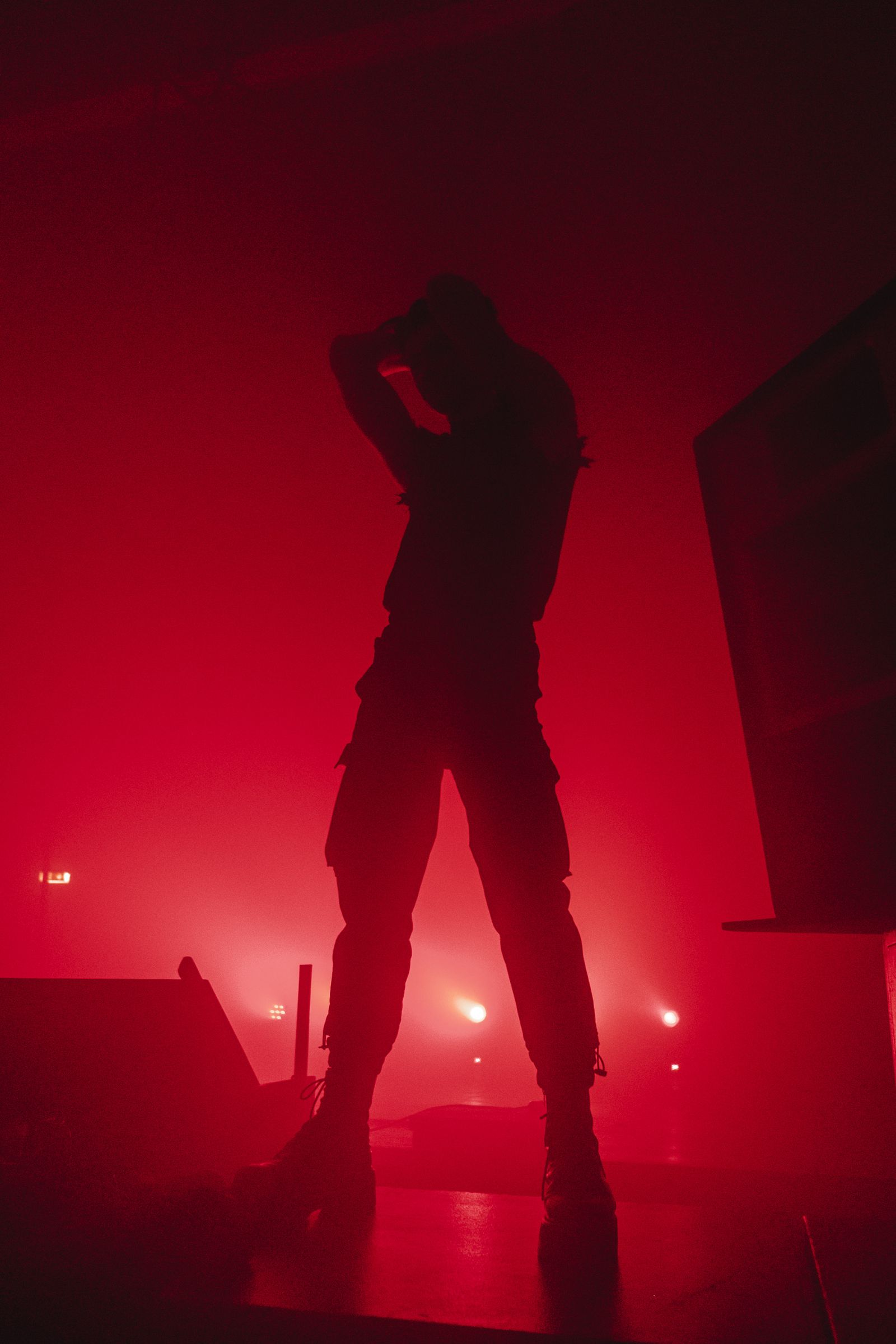 Figure in dense red stage fog